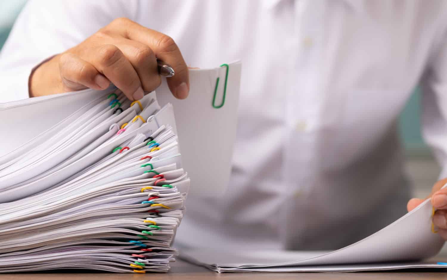 stock-photo-business-man-or-office-workers-with-white-shirt-holding-documents-for-writing-on-office-desk-stack-1914206386